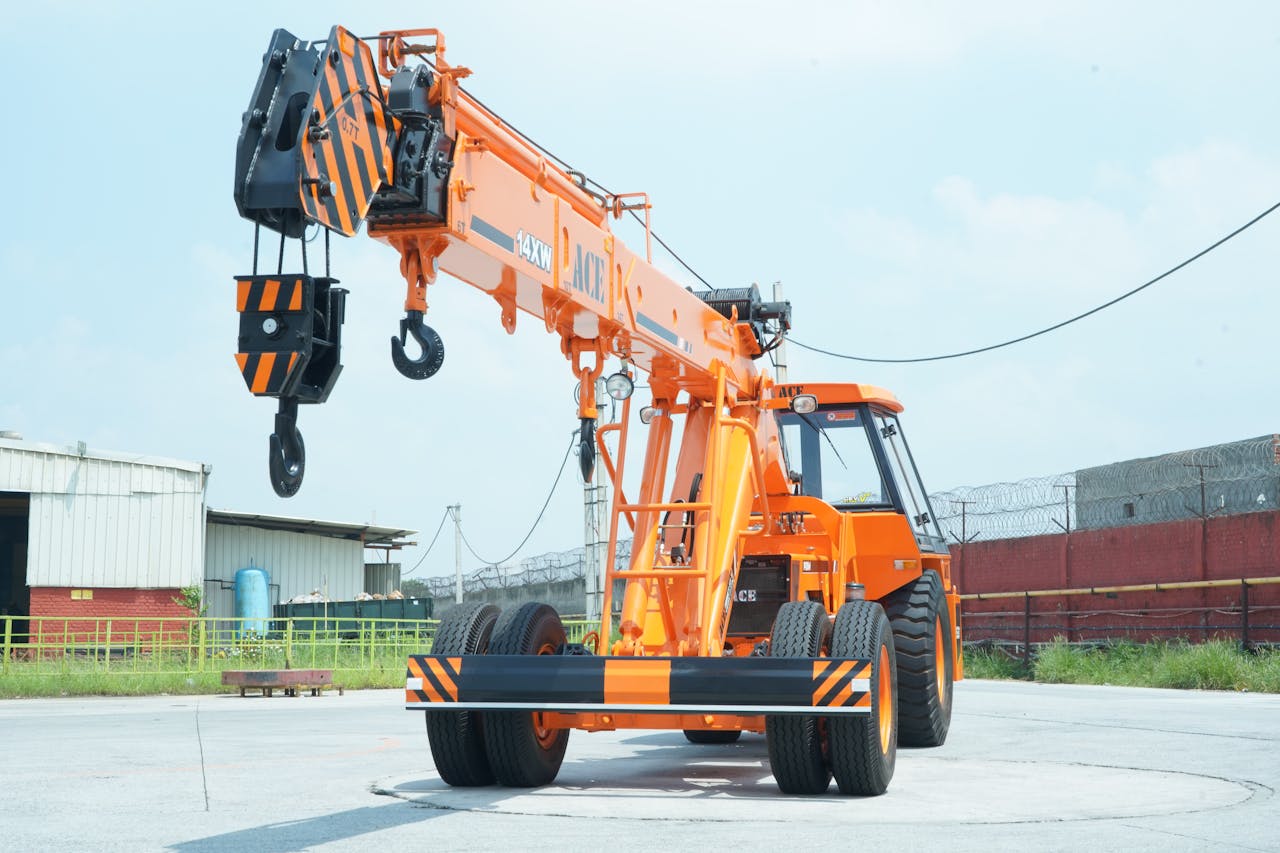 ACE 14XW orange crane in an industrial yard in Faridabad, India.